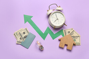 House figure with alarm clock, money, light bulb and arrow on lilac background. Price rise concept