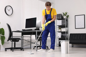 Cleaning service. Man washing floor with mop in office