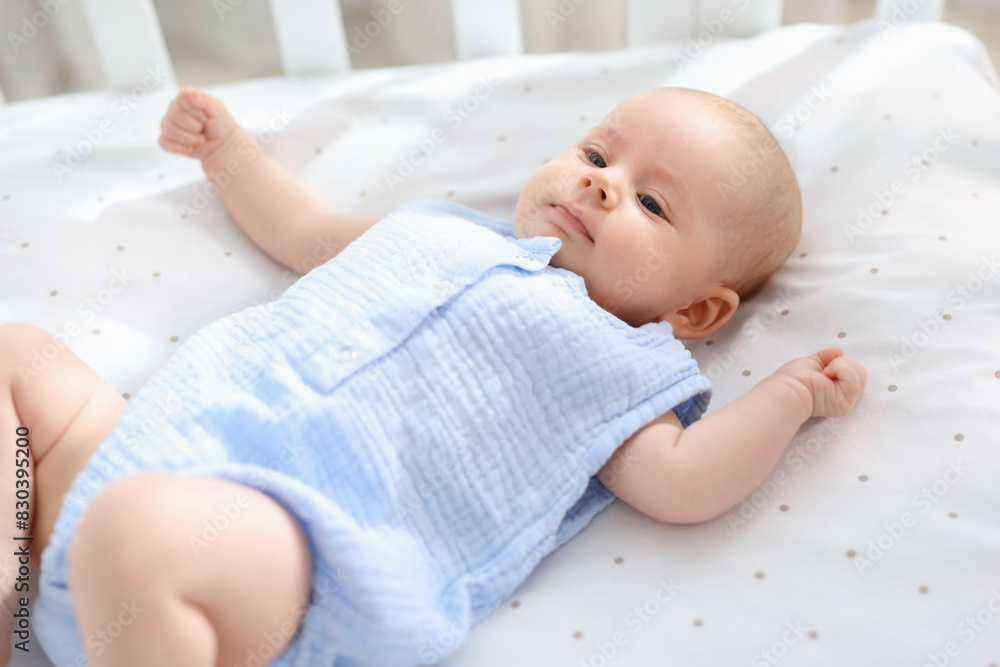 Sticker cute little baby lying in crib at home