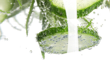 Refreshing cucumber water with bubbles isolated on white, closeup
