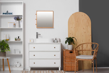 Interior of bathroom with sink and artificial plants