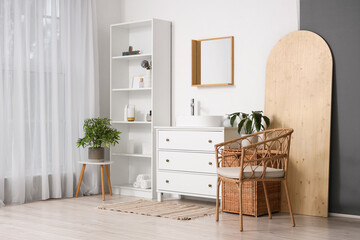 Interior of bathroom with sink and artificial plants