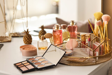 Makeup products on table in dressing room, closeup