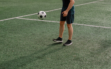 Unrecognizable man on soccer practice,  no face , juggling 