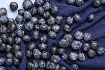 Sweet fresh blueberries on blue background, closeup