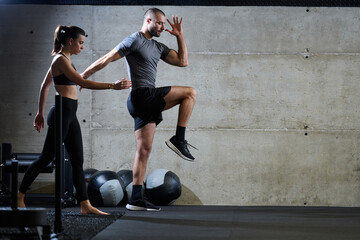 A fit couple in a modern gym, engaging in running exercises and showcasing their athletic prowess...