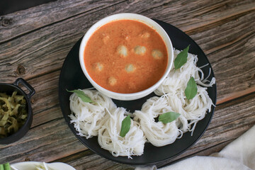 Rice noodles in a fish curry sauce with fish ball eat with vegetables. Traditional Thai food call 