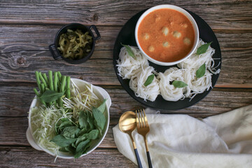 Rice noodles in a fish curry sauce with fish ball eat with vegetables. Traditional Thai food call 