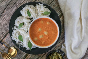 Rice noodles in a fish curry sauce with fish ball eat with vegetables. Traditional Thai food call 