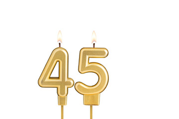 Golden number 45 birthday candle on white background