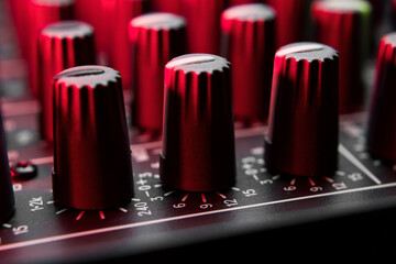 Close-up of professional audio sound mixer, mixing console showing eq knobs.