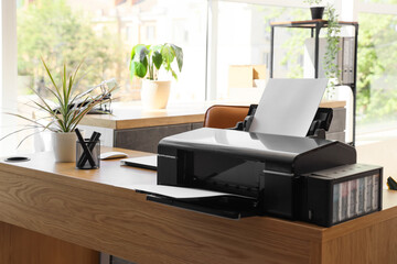 Modern printer on desk in office