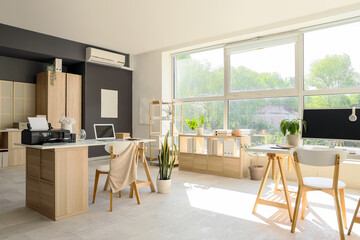 Interior of office with shelf units, desks and printer