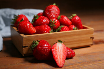 Box with sweet fresh strawberries on wooden table
