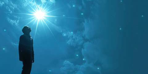 Fototapeta premium Hope (Light Blue): A figure looking up at a bright star, symbolizing hope and inspiration