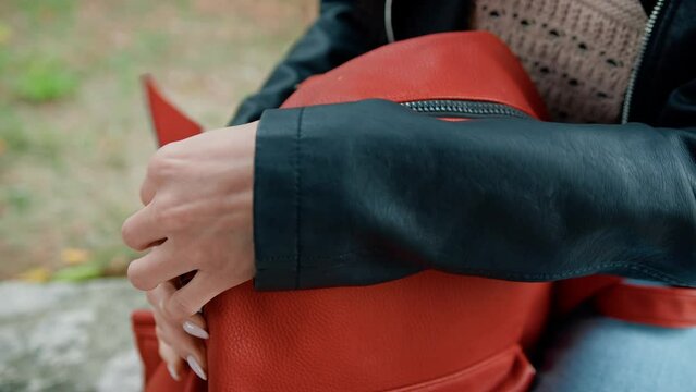 Opening The Zip Of A Red Backpack