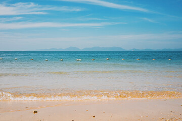 Fototapeta premium Sandy beach, sea on a beautiful clear day with waves.