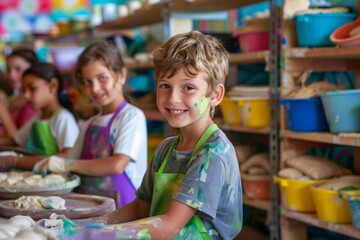 Young boys and girls creating pottery in summer art camp