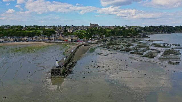 Cale de la Fenetre pier and beach during low tide, Brittany in France. Aerial drone backward