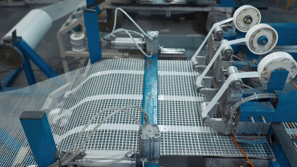 Automated Polymer Mesh Machine. Creative. Machines laying heating wires on polymer grid. Industrial...