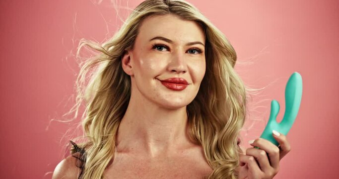 Woman, cosmetics and lipstick with sex toy in erotic satisfaction, desire or pleasure on a studio background. Portrait of female person, model or blonde adult with exotic tool or sexual education