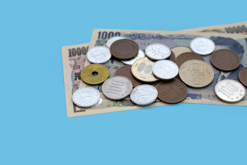 Japan money, Banknotes with coins on blue background.