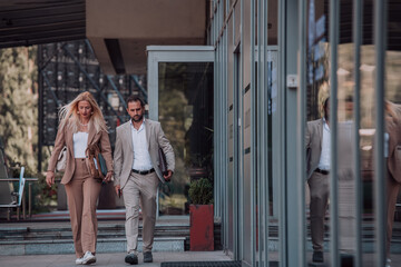 Modern business couple after a long day's work, walking together towards the comfort of their home, embodying the perfect blend of professional success and personal contentment.