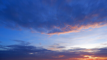 A stunning sunset with a gradient sky transitioning from deep blue at the top to warmer hues of...