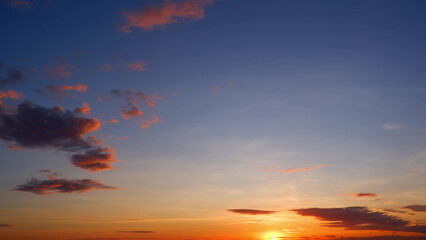 A beautiful sunrise with the sun peeking over the horizon, casting a warm glow. The sky transitions...