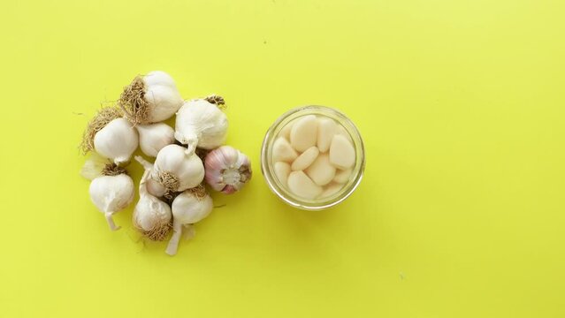 top view of garlic on yellow background,