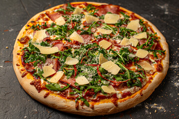 Prosciutto and Arugula Pizza with thinly sliced prosciutto, arugula, and shaved parmesan.