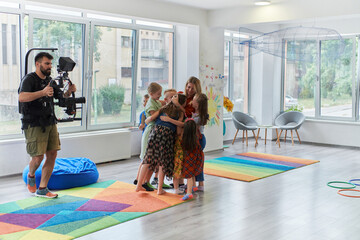 Cameraman films the joyful play and creative exploration of children at a preschool