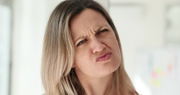 Portrait of woman with disgust on face