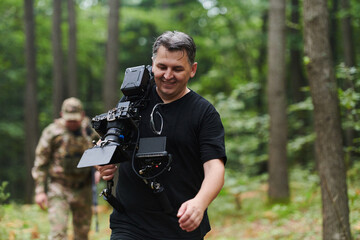 A videographer captures the intensity of a perilous military operation, documenting soldiers in action amidst the dense forest, showcasing the hazardous conditions and tactical maneuvers undertaken by