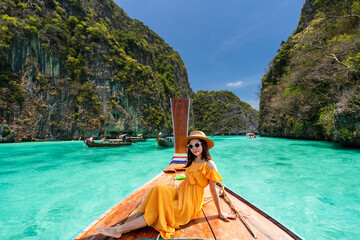 Young woman traveler relaxing and enjoying at Pi leh Lagoon at ko Phi Phi lay island in Krabi, Thailand, Summer vacation and Travel concept