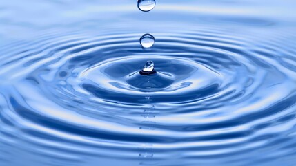  A close-up of a single blue water droplet against a vast blue sky