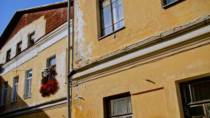 Old residential building facade with scuffed plaster. Stock footage. Old apartment building on a...