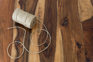 close-up view of a coil of raffia rope on a wooden table