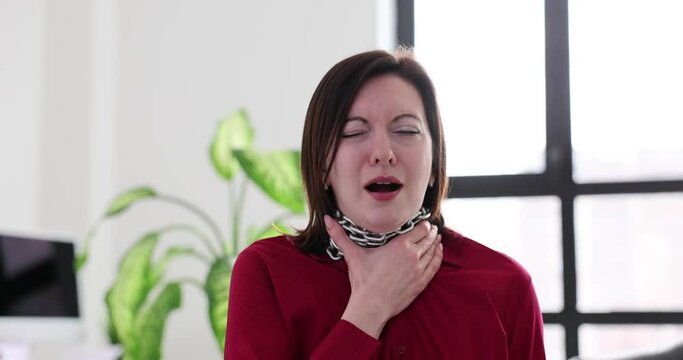 Woman with an iron chain around her neck and a sore throat