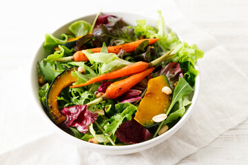 Green salad with grilled carrot, roasted pumpkin and green leaf.