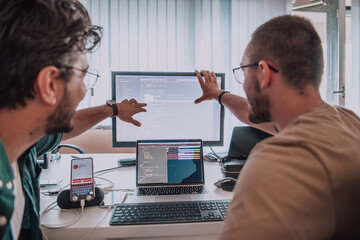 Programmers engrossed in deep collaboration, diligently working together to solve complex problems...