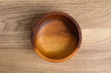 A wooden bowl on wooden background, Kitchen utensil, Table top view