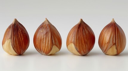 Obraz premium A trio of nuts sits on a white table, accompanied by a pair of scissors and a single sheet of paper