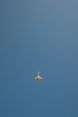 Bottom view of business jet airplane take off from an airport at daytime