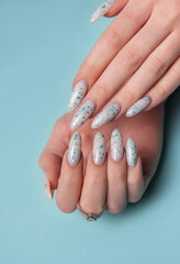 Female hands with blue nail design. Blue nail polish manicure.