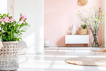 Beautiful interior design composition in minimalist fashion with pink tones, minimal furniture and copyspace for text.