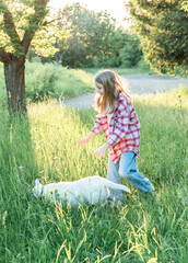 Fototapeta premium A child with a dog in nature