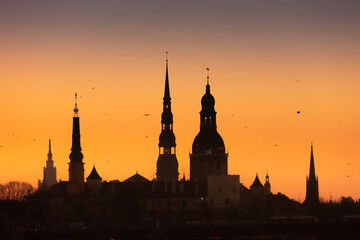 A beautiful Riga cityscape during colorful sunrise. Buildings against colorful sky. Northern Europe...