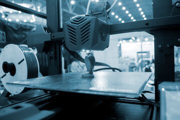 3D printer working close-up. 3D printer prints model from molten plastic close-up. 3D printer printing object. Additive progressive high-tech technology. New modern prototyping technologies.