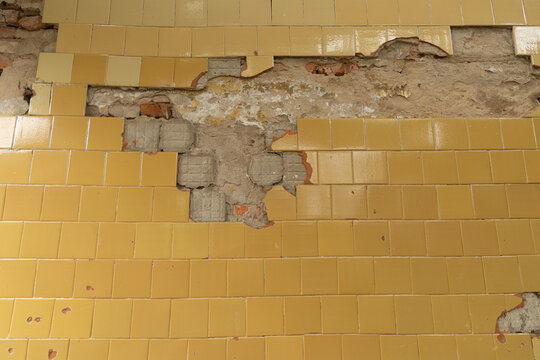 An old enamel tile wall texture. Cracked, abandoned building wall from Soviet times in Latvia, Europe.